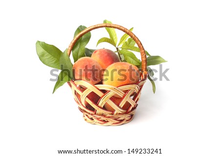 peaches in a basket isolated on white