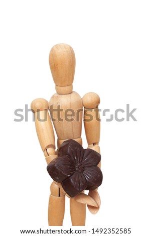 Wooden doll holding a chocolates bonbon flower