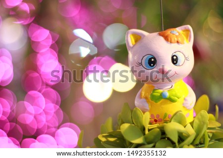 Abstract image. Cutie cat doll on bokeh background.