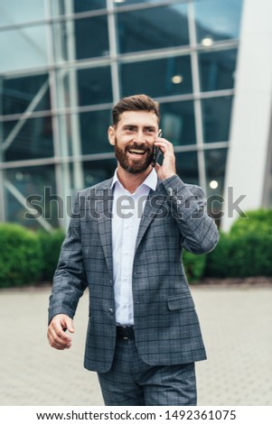 Joyful businessman dancing and talking phone about his new career	