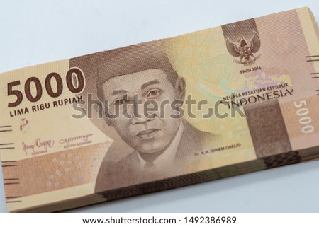 A close up shot of indonesian rupiah banknote of five thousand rupiahs (rp. 5000) denomination with Idham Chalid portrait printed on the paper
