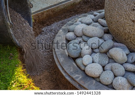 gritting material filled into the curb of a garden fountain