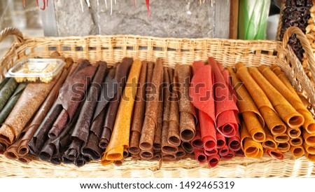 Tklapi - traditional georgian fruit pastila selling at market. . Delicious and healthy Georgian desserts. Royalty-Free Stock Photo #1492465319