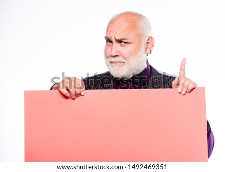 Senior means experienced. Senior man recommend something. Elderly people. Man bold head and gray beard hold poster for advertisement copy space. Senior holding blank sign board and looking at camera.