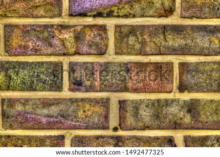 Very detailed texture of yellow brick walls on aged and weathered buildings in high resolution