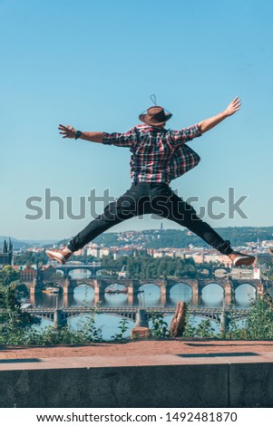the man jumping with happiness. beautiful view of the old city of Prague, Praha, tourist tour in Europe, vacation. having fun.