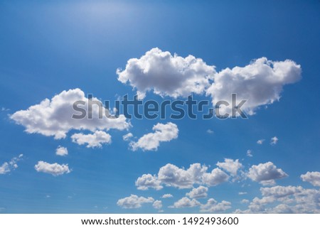 clouds on a blue sky in sunny light, many clouds