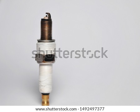 Spark plug of car or motorcycle isolated on white background. Automotive sparepart