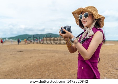 traveller woman taking a photo with camera in countryside