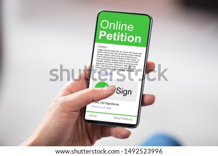 Man Looking At Online Petition Form On Smartphone