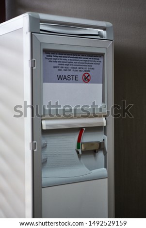 Close up aluminum trash with no smoking sign.