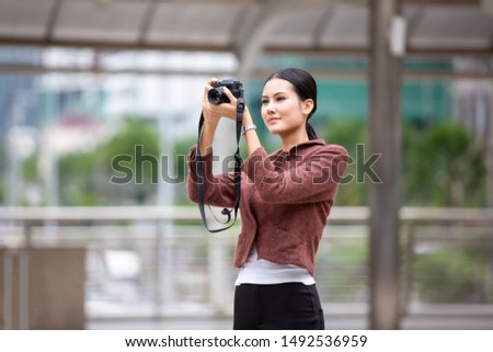 Candid portraits of business women holding camera and taking photo outdoor