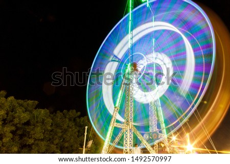 beautiful eye catching colorful giant ferris wheel, long exposure photography using tripod during low light situation, adds beauty to the photograph
