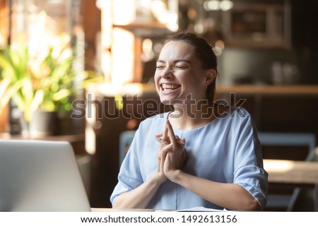 Excited funny woman student winner celebrating success victory sit at office table with laptop, euphoric businesswoman overjoyed by new opportunity, online bid or scholarship win, good test result