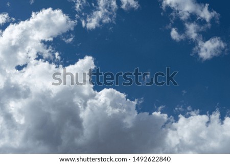 White clouds framing a deep blue sky