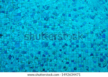 Swimming pool blue mosaic rock bottom. Texture. Background.