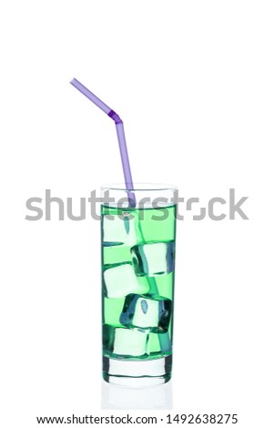 Green drink with ice cubes in a glass on a white background. Chilled cocktail exotic. Tonic liquid directly from the bar.