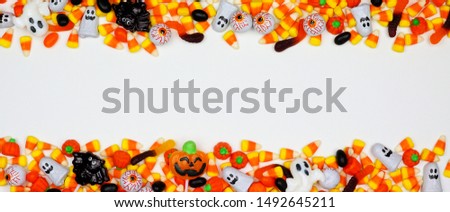 Halloween candy double border banner. Top view on a white background with copy space.