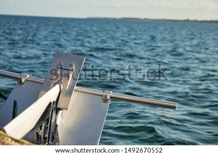 Catamaran anchor with the blue sea as a background. Royalty-Free Stock Photo #1492670552