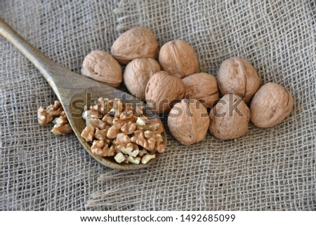On burlap, peeled walnuts peeled on a wooden