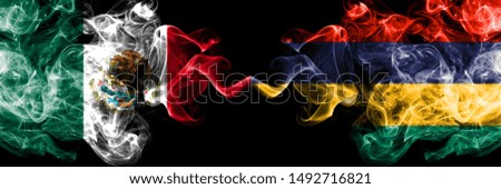 Mexico vs Mauritius, Mauritian smoky mystic flags placed side by side. Thick colored silky abstract smokes banner of Mexican and Mauritius, Mauritian