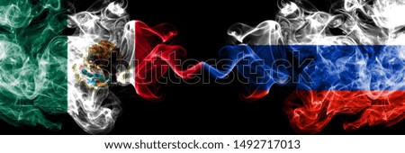Mexico vs Russia, Russian smoky mystic flags placed side by side. Thick colored silky abstract smokes banner of Mexican and Russia, Russian
