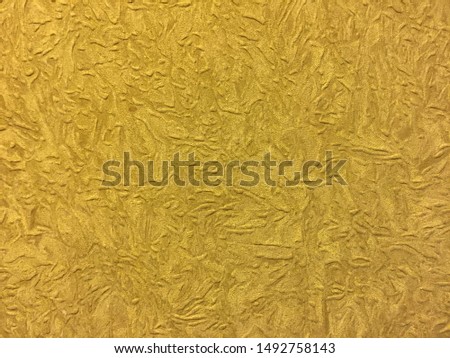 The texture of the wall with patterns of gold color