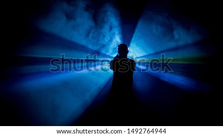 dark man laser blue background