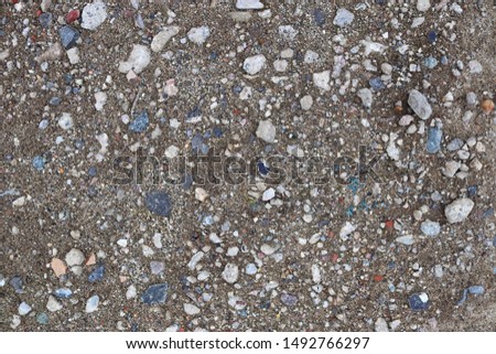 Detailed close up view on a brown sand ground texture in high resolution