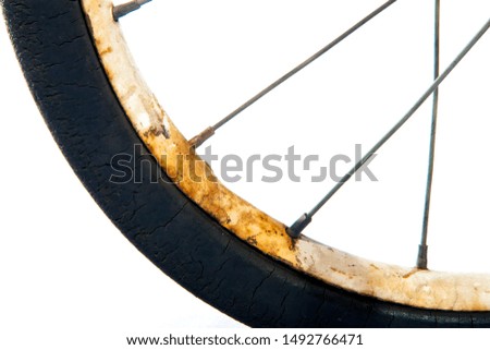 Vintage tricycle wheel. Rusty, metal texture. Detail.