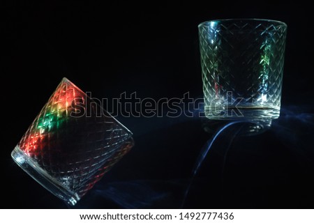 thick glasses illuminated by the coloured light