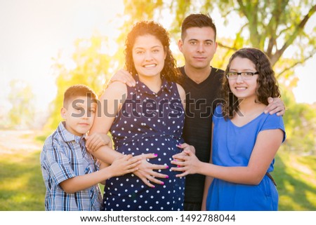 Hispanic Pregnant Family Portrait Outdoors.