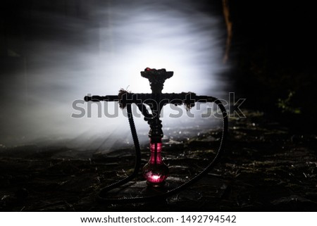 Hookah hot coals on shisha bowl with black background. Stylish oriental shisha at the forest during night time