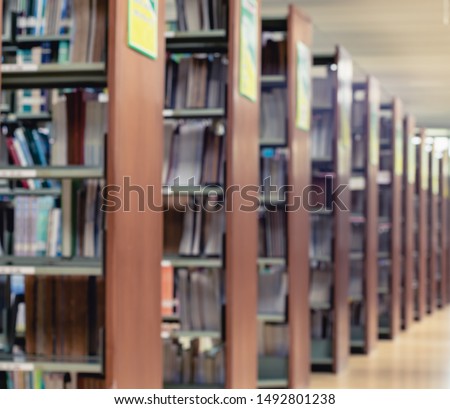 Picture of blur bookshelf as background in library with copy space. Photo concept of education, knowledge, traditional learning, and literature.
