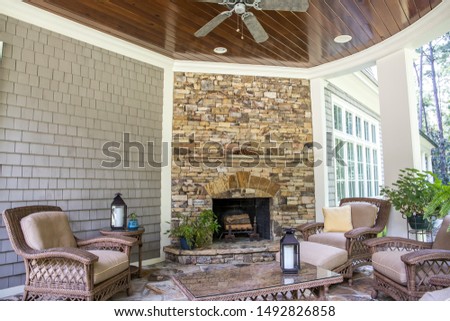 Back Stone Patio Porch of large Home with an outdoor fireplace Royalty-Free Stock Photo #1492826858
