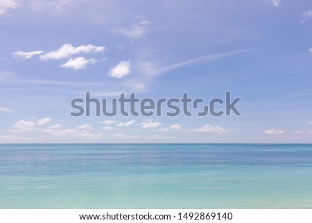 Turquoise water and blue sky as background image. Caribbean sea panorama, Maldives islands, Hawaii, Thailand ocean waters, turquoise tropical paradise island. Panorama of sea waves. Peaceful nature