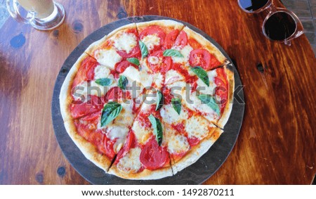 pizza margherita. fresh tasty vegetarian pizza on the wooden background.