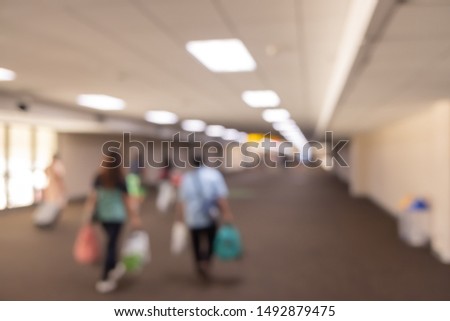 Blur passengers traveller for holiday or business trip in airport background.