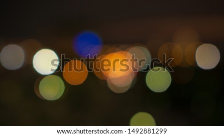 Bokeh image of blurred lighting, circle shape of shiny lights from the city in dark  night