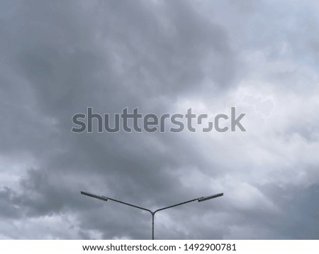 Low Angle View of Lighting Post Against Dark Cloudy Sky Background