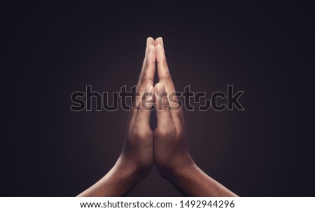 Praying hands with faith in religion and belief in God on dark background. Power of hope or love and devotion. Namaste or Namaskar hands gesture. Prayer position. Royalty-Free Stock Photo #1492944296