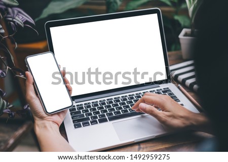 mockup image blank screen computer,cell phone with white background for advertising text,hand man using laptop texting mobile contact business search information on desk in office.design creative work