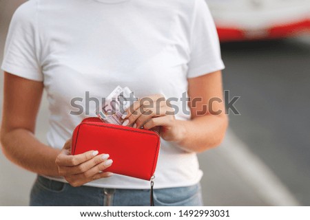 Euro Money. Girl's holding euro bills. Female hands gets money from the wallet. Euro cash background.