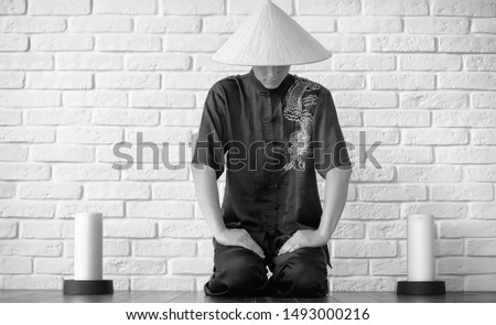 Asian young novice on a white brick wall background
