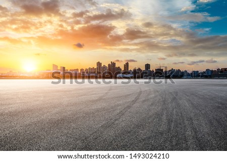 Asphalt race track and city skyline at sunset in Shanghai,China.