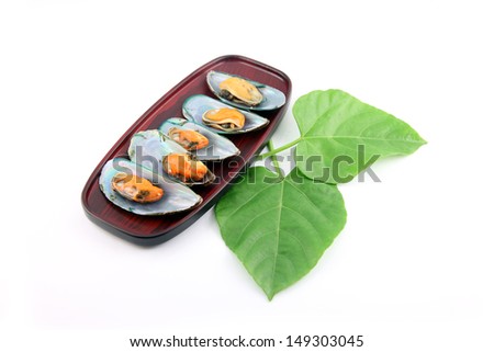 Mussel Picture on dish and Green leaves placed beside.