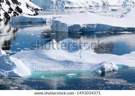 A small iceberg floats in the Antarctic waters of the Lemaire Channel in the Antarctic Peninsula, Antarctica