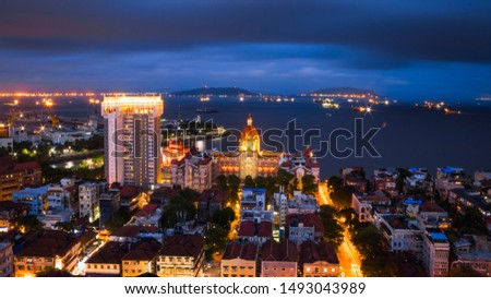 A beautiful night view of Hotel Taj Mahal Palace in Mumbai from the top of a highrise near it. The Taj Hotel and Gateway of India can be seen overlooking the Apollo Bunder in Mumbai. Royalty-Free Stock Photo #1493043989