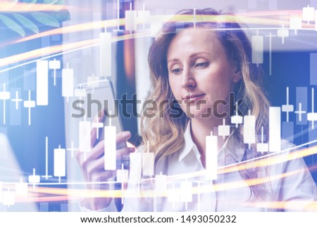 Candlestick chart in the foreground. In the background are business people with laptops, smartphones and other gadgets. Abstract financial background. Double exposure.