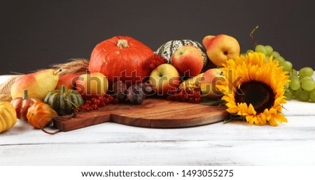 Autumn nature concept. Fall fruit and vegetables on wood. Thanksgiving dinner with sunflower